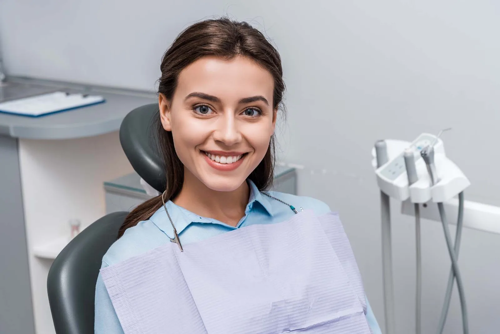 A smiling patient in the treatment chair at Refined Smiles in Cave Creek