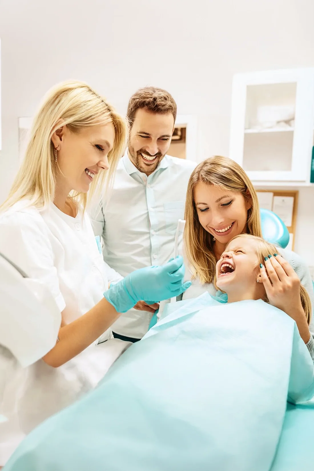 Dentist smiling with a family and young patient at Refined Smiles in Cave Creek